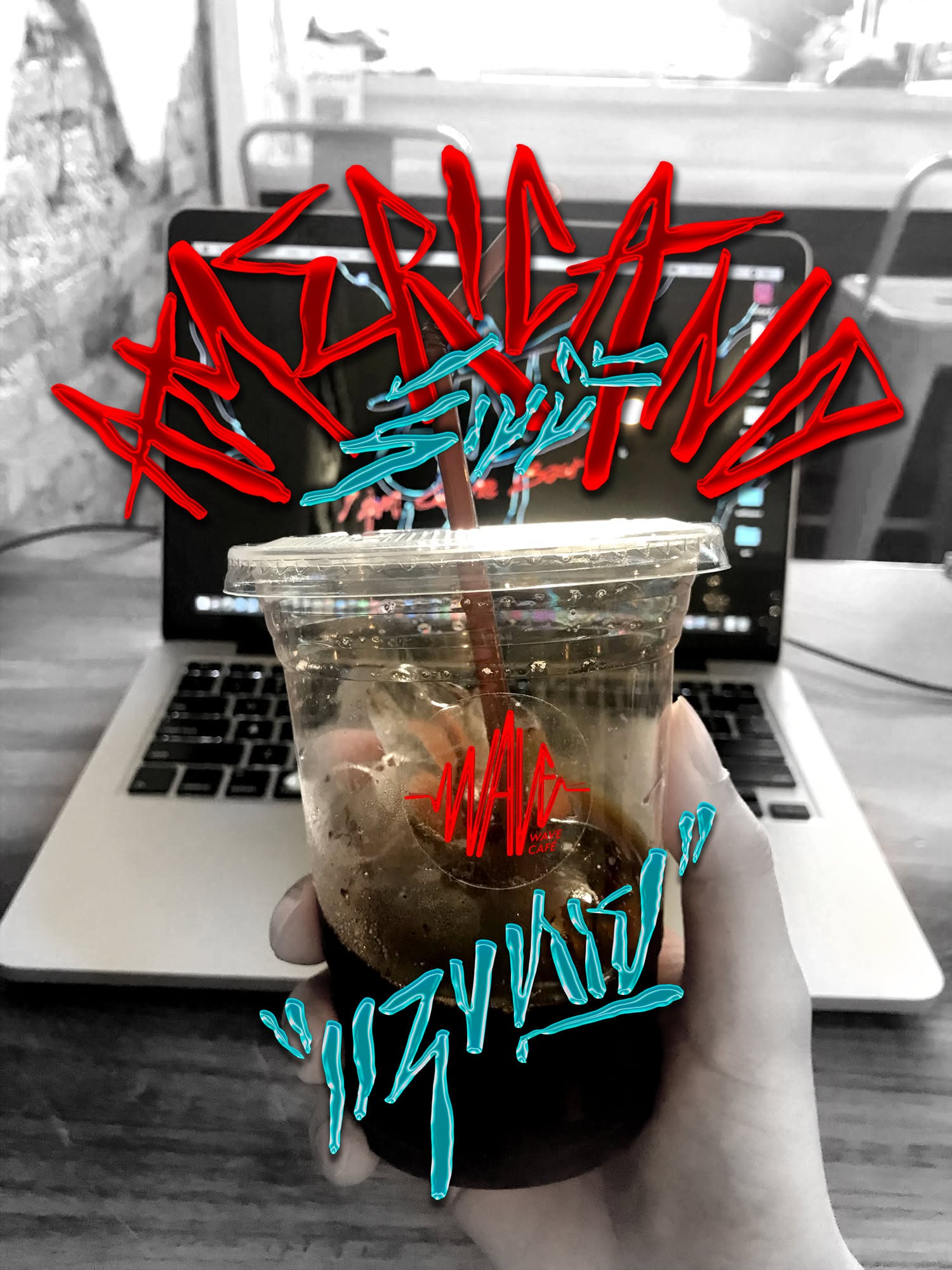 Desk with a laptop, notebook and iced coffee